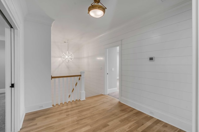 empty room with a chandelier and wood finished floors