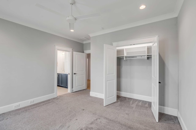 unfurnished bedroom with light carpet, baseboards, and a closet