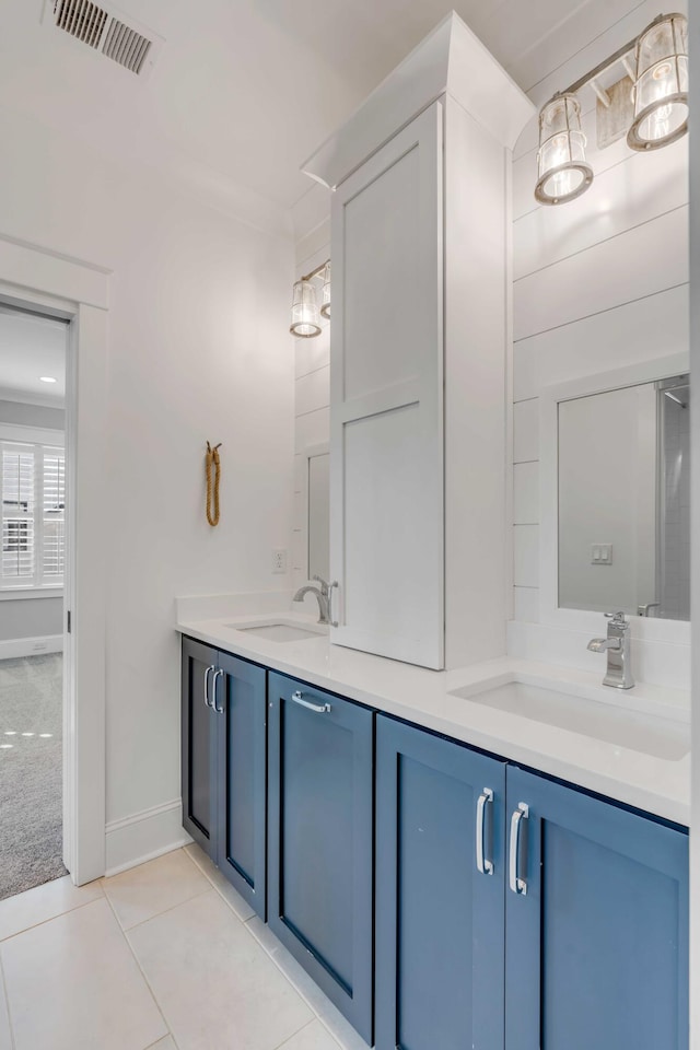 bathroom featuring double vanity, tile patterned flooring, a sink, and visible vents