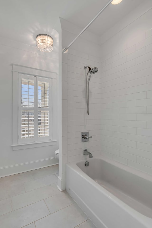 full bathroom with baseboards, shower / bath combination, toilet, and tile patterned floors