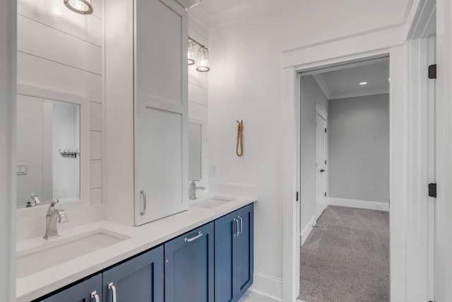 full bathroom featuring double vanity, baseboards, and a sink