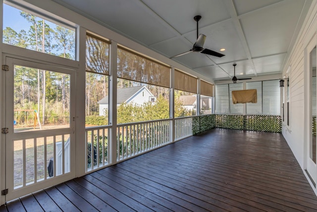 unfurnished sunroom featuring coffered ceiling and ceiling fan