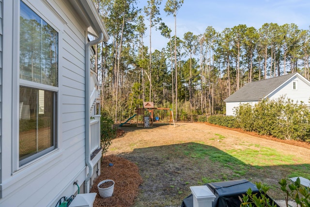 view of yard with a playground and fence