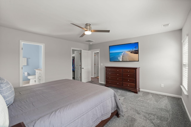 carpeted bedroom featuring ensuite bath and ceiling fan