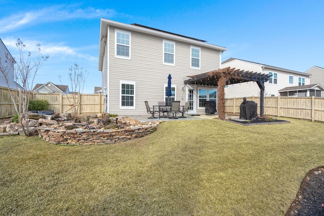 back of property with a patio, a pergola, and a lawn