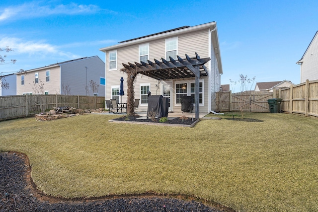 rear view of house with a pergola, a patio area, and a lawn