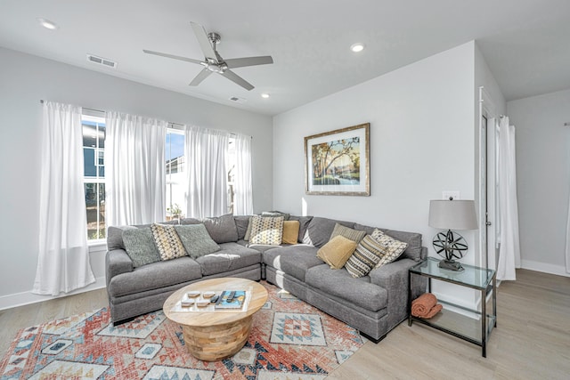 living room featuring ceiling fan and light wood-type flooring