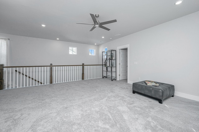 interior space featuring ceiling fan and light colored carpet