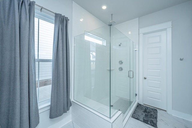 bathroom featuring a shower with door