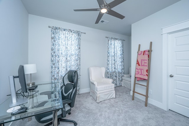 carpeted office space with ceiling fan