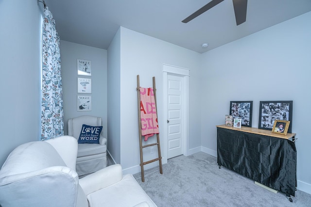 living area with ceiling fan and light colored carpet