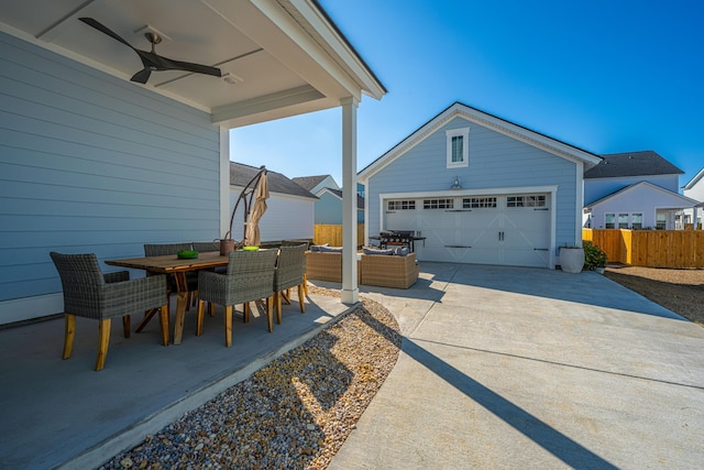 view of patio / terrace featuring an outbuilding, ceiling fan, a garage, an outdoor hangout area, and area for grilling