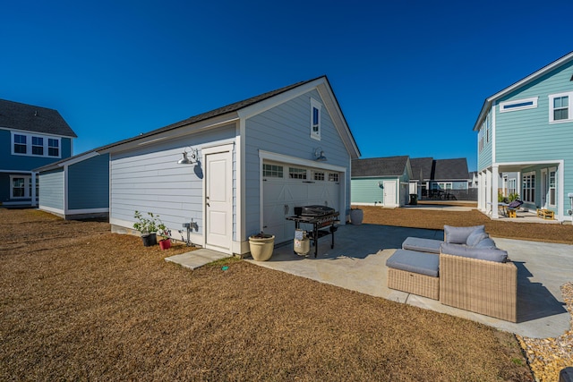 exterior space with a garage, a yard, and an outdoor structure