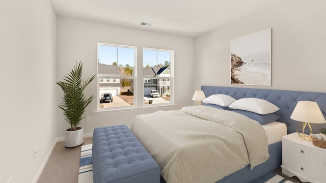 carpeted bedroom with visible vents and baseboards