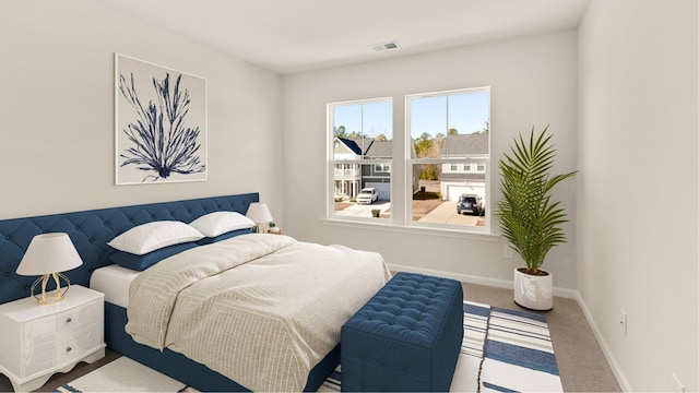 bedroom with carpet floors, visible vents, and baseboards