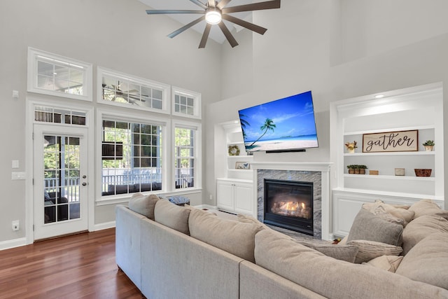 2720 Oak Manor Dr, Mount Pleasant, SC 29466 - living room with a ceiling fan, a towering ceiling, dark wood-type flooring, a high end fireplace, and baseboards