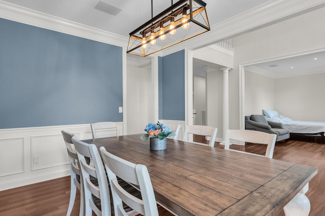 2720 Oak Manor Dr, Mount Pleasant, SC 29466 - dining area featuring wood finished floors, crown molding, wainscoting, decorative columns, and a decorative wall