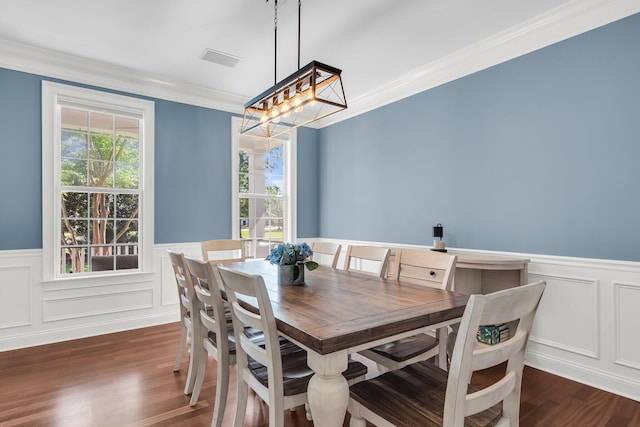 2720 Oak Manor Dr, Mount Pleasant, SC 29466 - dining space featuring a wainscoted wall, crown molding, a chandelier, dark wood-type flooring, and a decorative wall