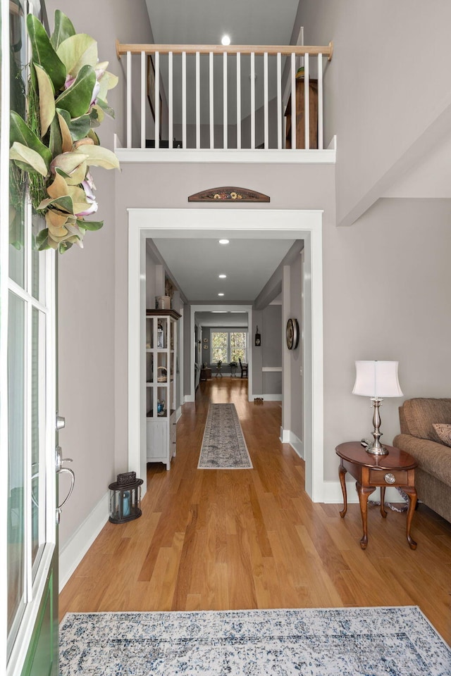 corridor with light hardwood / wood-style floors