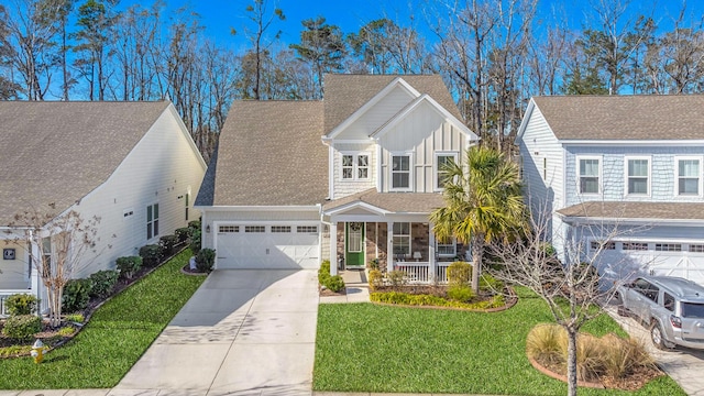 view of front of home featuring a front yard, a porch, and a garage