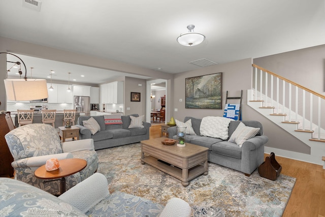 living room with light hardwood / wood-style flooring