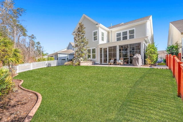 back of house with a patio area and a lawn