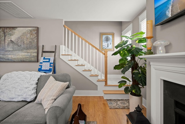 staircase with hardwood / wood-style flooring