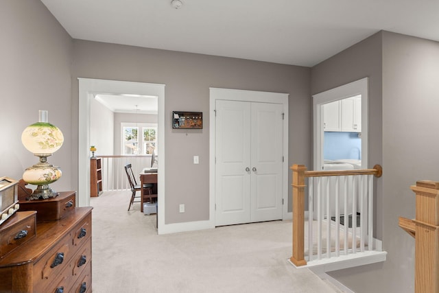 hallway with light colored carpet