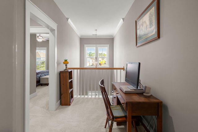 office space featuring plenty of natural light, light colored carpet, a notable chandelier, and ornamental molding