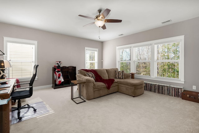 carpeted living room featuring ceiling fan