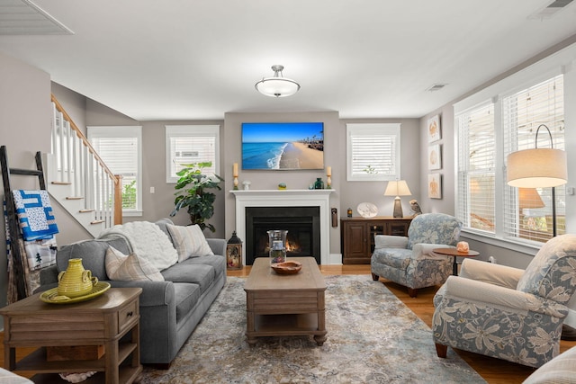 living room featuring dark wood-type flooring and a wealth of natural light