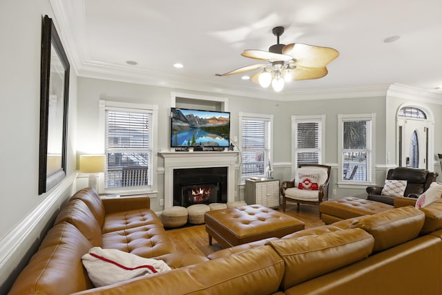 living room featuring ornamental molding, hardwood / wood-style floors, and a wealth of natural light