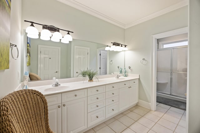 bathroom with ornamental molding, a shower with door, tile patterned flooring, and vanity