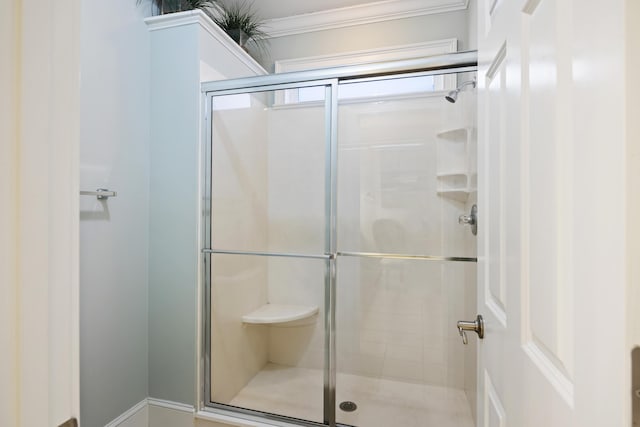 bathroom with a shower with door