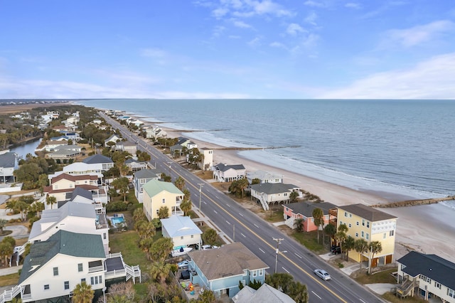 aerial view with a water view and a beach view