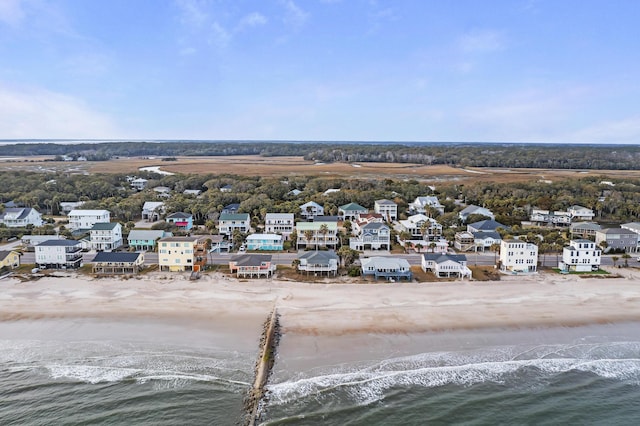 aerial view with a water view and a beach view