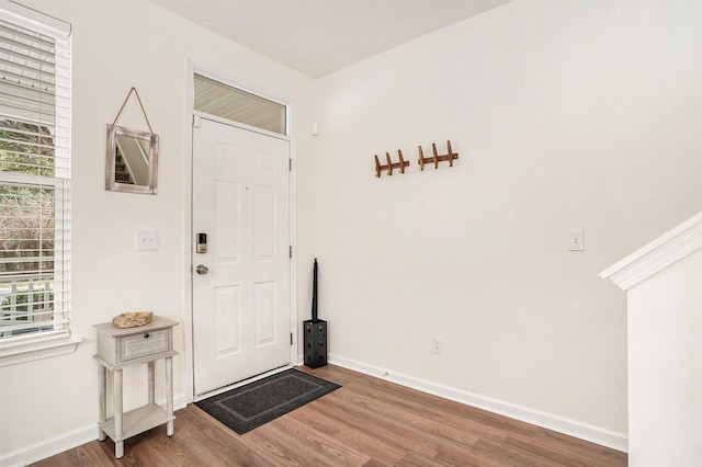 entrance foyer with baseboards and wood finished floors