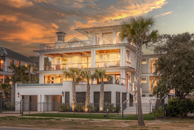 3803 Palm Blvd, Isle Of Palms, SC 29451 - rear view of property featuring a balcony, a fenced front yard, a ceiling fan, and stairs