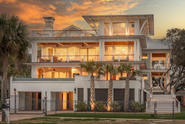 3803 Palm Blvd, Isle Of Palms, SC 29451 - rear view of house with a balcony, a fenced front yard, a ceiling fan, a gate, and stairs