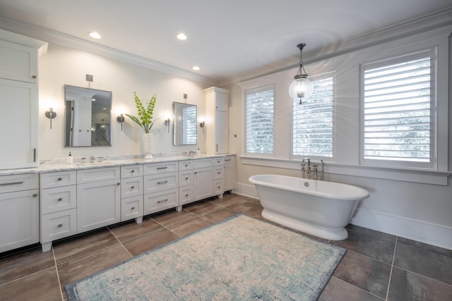 3803 Palm Blvd, Isle Of Palms, SC 29451 - bathroom featuring crown molding, healthy amount of natural light, double vanity, a soaking tub, and baseboards
