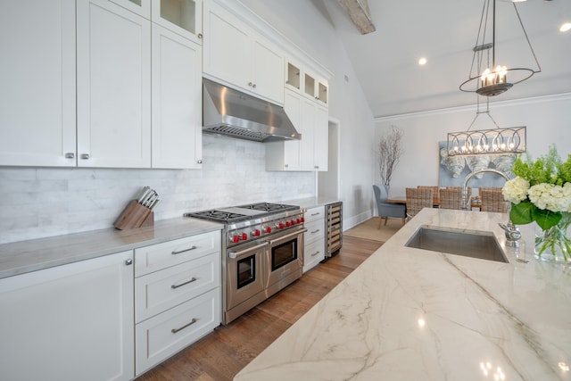 3803 Palm Blvd, Isle Of Palms, SC 29451 - kitchen with double oven range, under cabinet range hood, a sink, a chandelier, and decorative backsplash