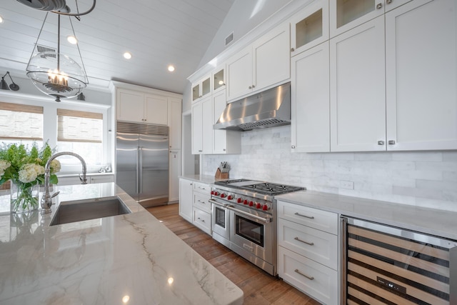 3803 Palm Blvd, Isle Of Palms, SC 29451 - kitchen featuring high quality appliances, under cabinet range hood, a sink, beverage cooler, and white cabinetry