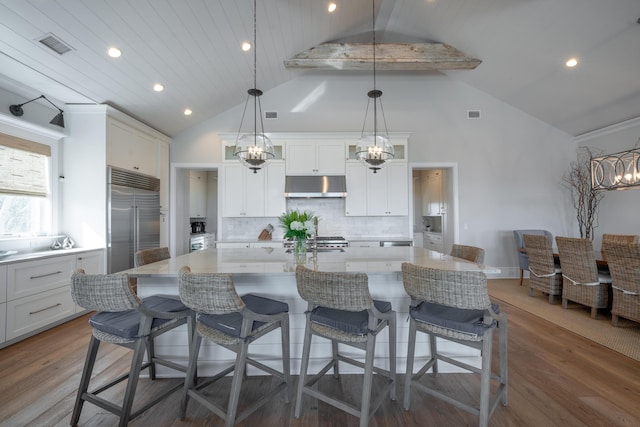 3803 Palm Blvd, Isle Of Palms, SC 29451 - kitchen featuring under cabinet range hood, built in fridge, a chandelier, wood finished floors, and recessed lighting