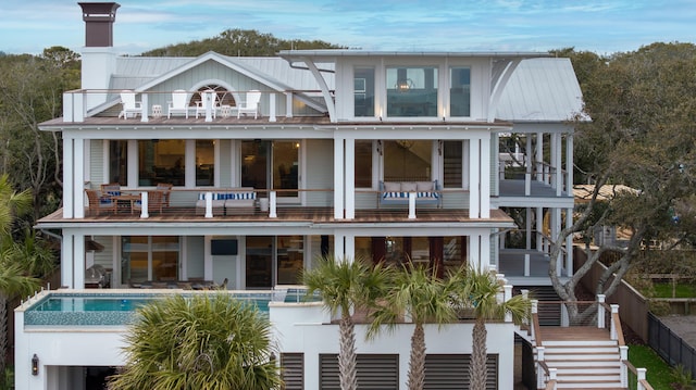 3803 Palm Blvd, Isle Of Palms, SC 29451 - rear view of property featuring a balcony, stairway, and an outdoor pool