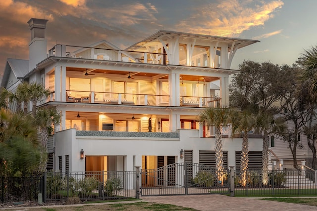 3803 Palm Blvd, Isle Of Palms, SC 29451 - back of house with a balcony, a fenced front yard, a ceiling fan, and a gate