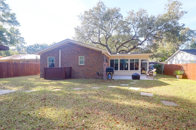 back of house with a yard and a patio