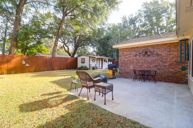 view of yard featuring a patio and an outdoor structure