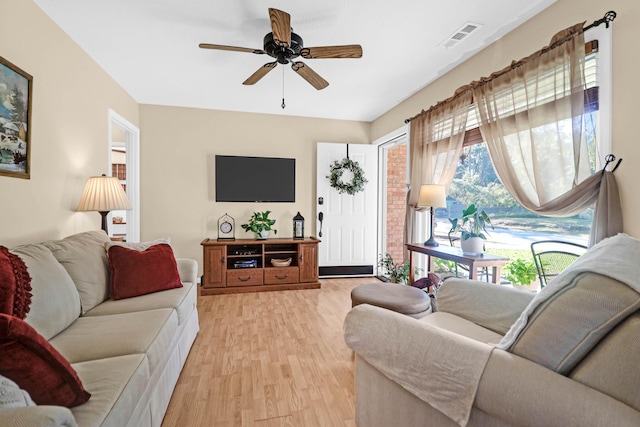 living room featuring light hardwood / wood-style flooring and ceiling fan