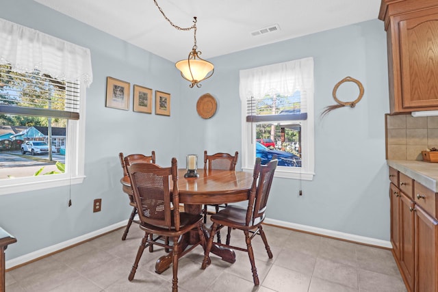 tiled dining area with a healthy amount of sunlight