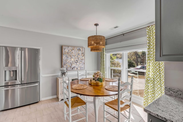 dining space featuring light tile patterned floors and visible vents